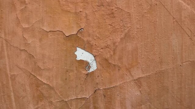 Peeling paint on the wall. Weathered rough painted surface with patterns of cracks and peeling. Wide panoramic grunge texture for background