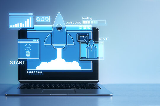 Close up of laptop on desk with creative glowing rocket ship hologram on blue background. Start up and business beginning concept. 3D Rendering.