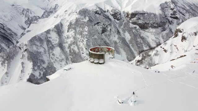 Gudauri, Georgia - December 26, 2021: Aerial view of Russia-Georgia Friendship Monument located on the Georgian Military Highway in the Caucasus.