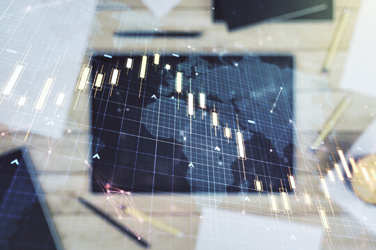 Multi exposure of abstract creative financial chart with world map and digital tablet on background, top view, research and analytics concept