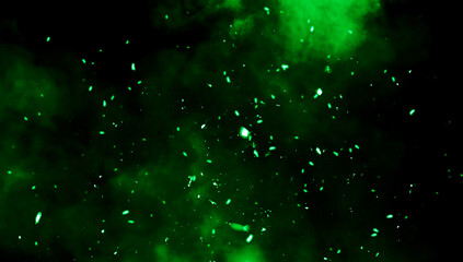 Blurred green fire embers sparks on black background . Texture isolated overlays. Concept of particles, sparkles, flame and light.