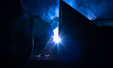 Welding steel structures and bright sparks in steel construction industry. Blue tone