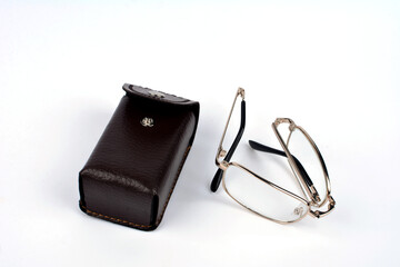 Folding reading glasses with hard case.