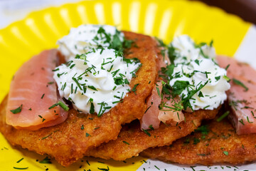 Potato pancakes with sour cream and herbs