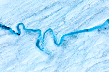 An aerial view of an iceberg and river. Winter landscape from a drone. View of the moraines. Landscape from the air. River on a moraine. © biletskiyevgeniy