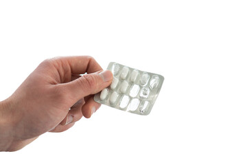 Man hands holding pills in a blister pack isolated on white background