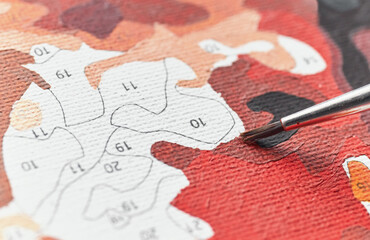 Painting by numbers, close up of brush tip on canvas, selective focus. - 733367937