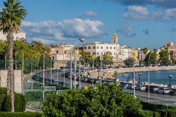 Waterfront of Lungomare Imperatore Augusto street in Bari with harbour in the background. Bari, Puglia region (Apulia), southern Italy, Europe, September 18, 2022