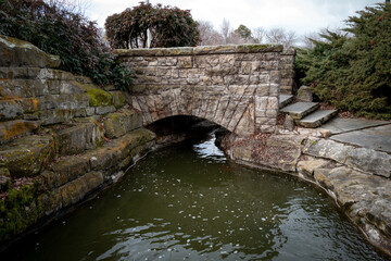 Fototapeta na wymiar Stone bridge over a small stream