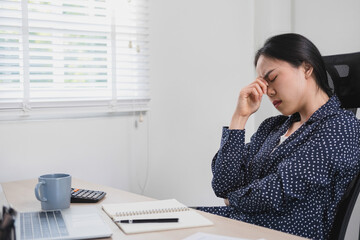 Businesswoman is thinking and is stressed about work.