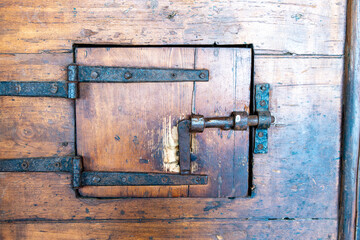 Small Ancient Wooden Door  in a bigger door with Iron Lock in Historic Building