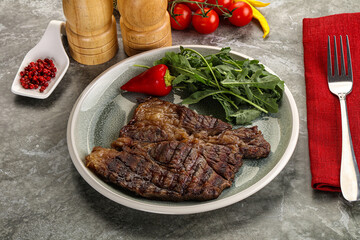Grilled chuck roll steak with arugula