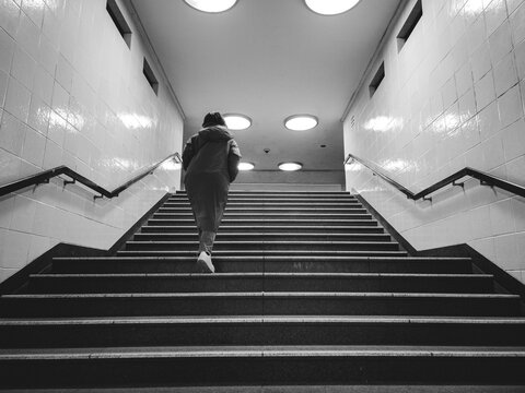 person walking up the stairway in a subway in Berlin