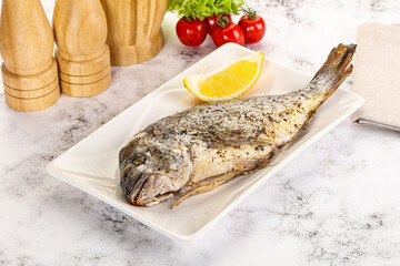 Baked Dorado fish served lemon