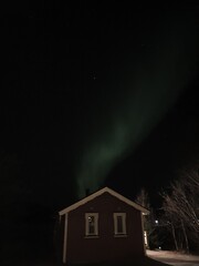 house at night and northern light