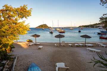 Panorama shot of motor boats parked at a dock named Agios Nikolaos harbour against blue sea and mountain in one of the ionian island of Zakynthos, Greece