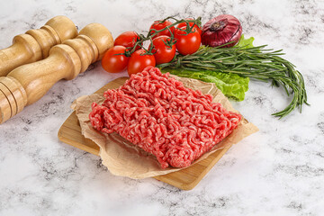Raw minced beef meat on cutting board