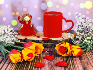 Red cup of coffee with heart, fairy doll, bouquet of tulips and gypsophila with bokeh effect. Happy...