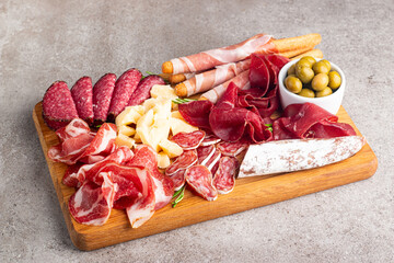 Charcuterie board. Antipasti appetizers of meat and cheese platter with salami, prosciutto crudo or jamon and olives