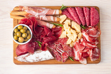 Charcuterie board. Antipasti appetizers of meat and cheese platter with salami, prosciutto crudo or jamon and olives