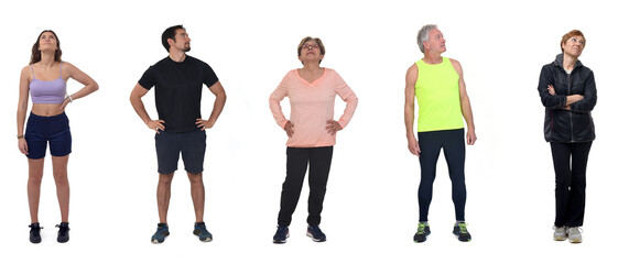  group of women and man dressed in sportswear looking up on white background © Curto