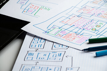 Development and sketches on paper of a custom mobile application on the desktop, graphic design