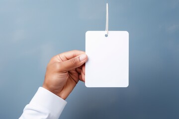 White paper tag held in hand. blank Space For Text, Blank space for text or logo, Ai generated