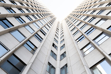 Very tall white building with glass windows seen from below in Madrid