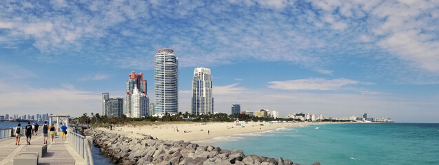 South Pointe Park Pier in Miami South Beach with blue sky and view of beach and skyline