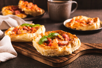Chicago pizza pot pie with sausage, tomatoes and cheese on a board on the table