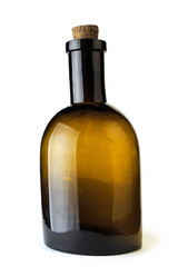 Old-fashioned brown glass bottle for medicine, essential oil, with a cork. Antique poison or medicine bottle on white background.