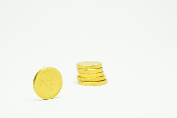 Pile of gold chocolate coins isolated on white background, stack of coins, heap of chocolate money coins