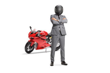 Man in a suit and tie with a helmet standing in front of a red motorbike