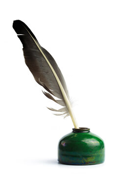 Ancient bottle of ink with feather isolated on a white background