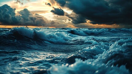 The scene captures turbulent ocean waves during what appears to be either sunrise or sunset. The sky is filled with a combination of dark and softly lit clouds, suggesting that the sun is low on the h