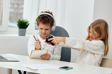 Happy Siblings Taking a Selfie with Their Smartphones while Sitting on the Couch at Home