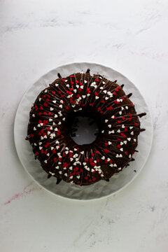Top view of an apetite chocolate cupcake. Cupcake covered with icing and decorated with red hearts