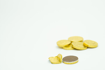 Stack of chocolate coins isolated on white background copy space, group of golden chocolate coins money
