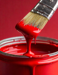 bucket of red paint and brush