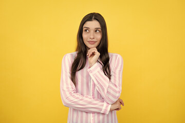 Portrait of young woman thinking, looking up empty space. Thoughtful serious model in studio looking away. Girl thought choose decide solve problems.