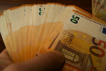 50 euro banknotes in a man's hand, close-up. High quality photo
