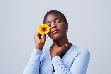 Woman with yellow flowers shows emotions.