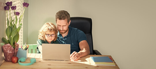 Banner of home school of father and son with laptop at home, concentrated father and son in glasses...