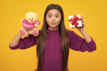Funny face. Emotional teenager child hold gift on birthday. Funny kid girl holding gift boxes celebrating happy New Year or Christmas.