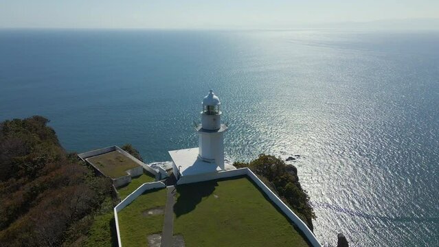 Cinematic aerial shot of lighthouse at Cape Chikyu in Muroran City in Hokkaido, Japan