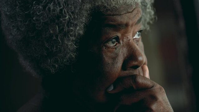 Contemplative African American elderly woman gazing out in the distance in deep mental reflection. One black lady thoughtful expression pondering solution
