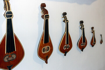Cretan lyres hanging on a wall in an instrument shop. The lyre with three strings is the most...