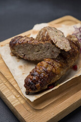 Delicious Lyulya kebab on a wooden board. Close-up 