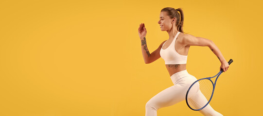 Fototapeta na wymiar happy tennis player running with racket on yellow background, badminton. Woman isolated face portrait, banner with mock up copyspace.