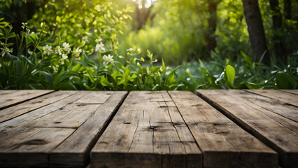 Spring or summer nature background with blurred green grass, trees and wooden table